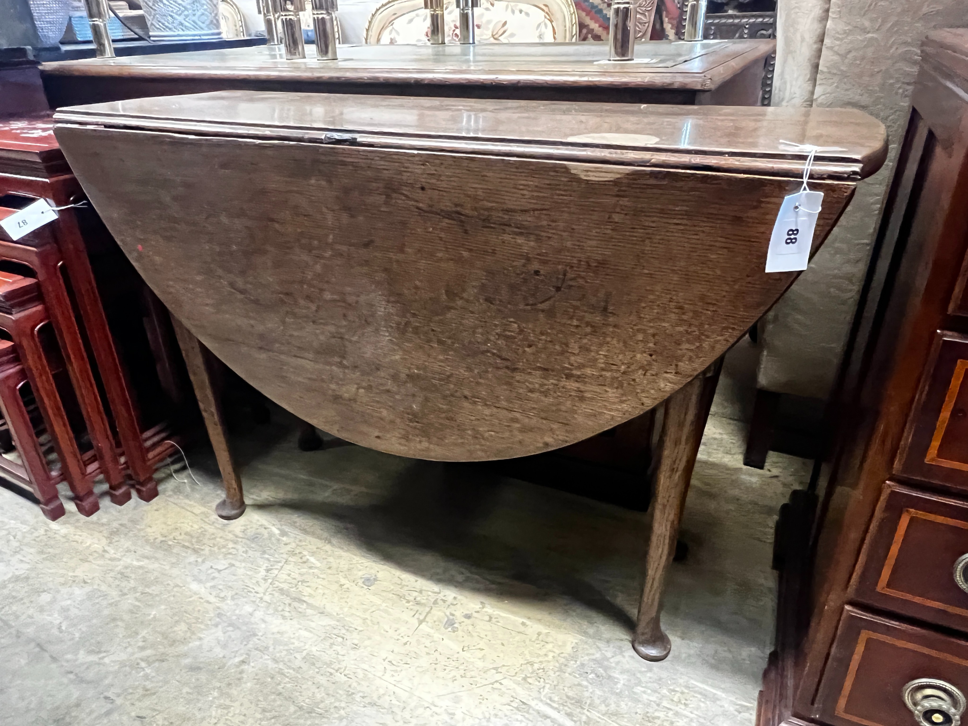 An 18th century oak drop leaf padfoot dining table, length 104cm, depth 37cm, height 72cm